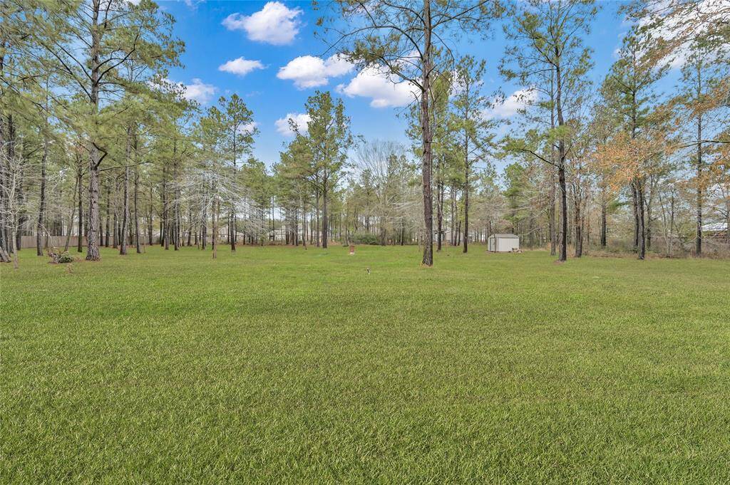 This carefully CLEARED ONE-ACRE LOT maintains mature hardwood trees and lush greenery, ideal for relaxation or entertaining. This wide-open back yard is ready for a pool or other outdoor fun!