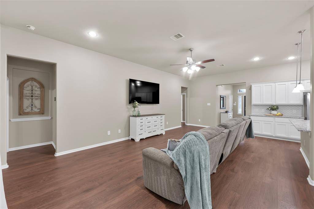 From the entry you walk into the open Living Room and Kitchen seeing all the way through to the picturesque back yard. Luxury Vinyl Plank flooring covers the entire home and was just installed in 2024!