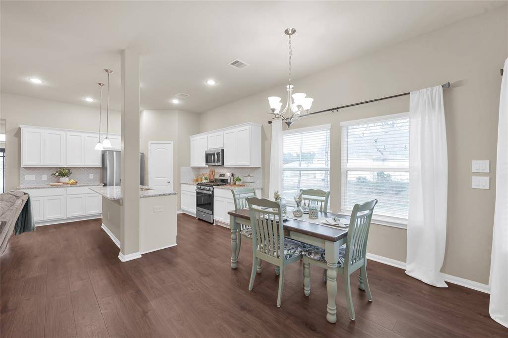 You have views of back and side yards from the Breakfast Room and Kitchen with multiple windows for natural light.
