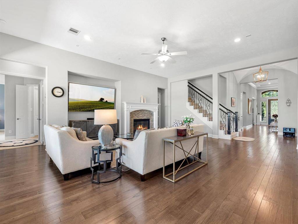 Alternative view of the living room featuring a lovely fireplace and wall inset! Perfect for the entertainment system!
