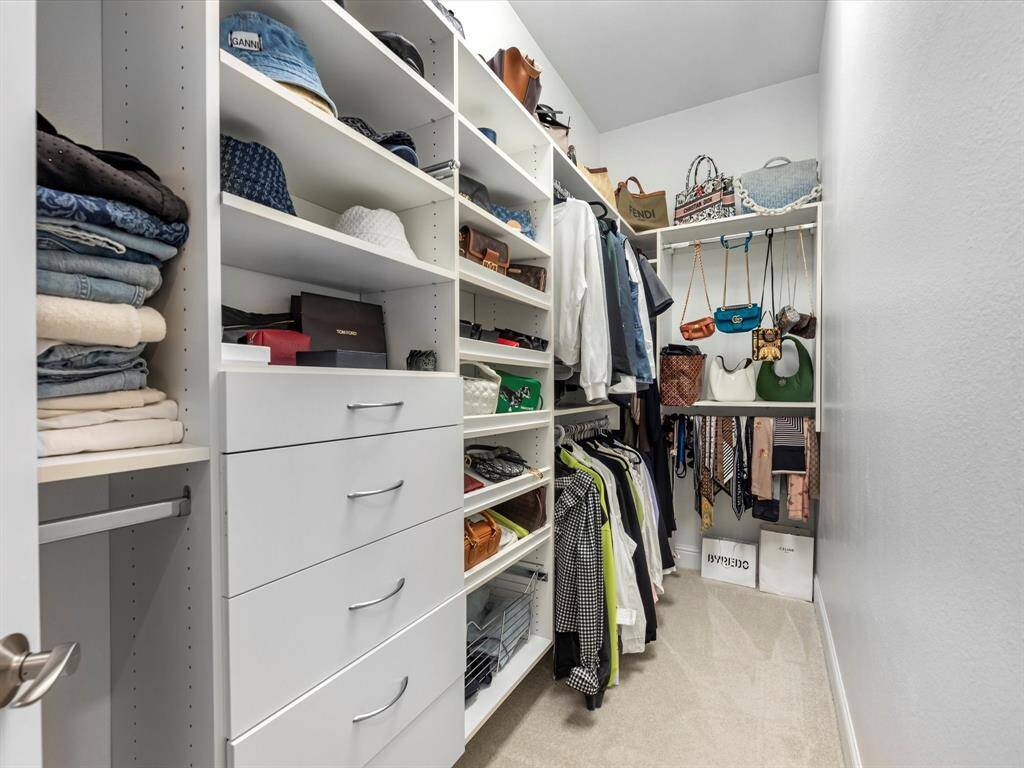Custom closet organizer in the primary closet is perfect for storage!