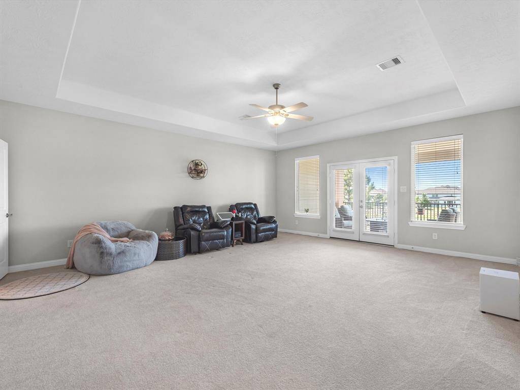 Upstairs boasts a spacious game room and access to the large balcony.