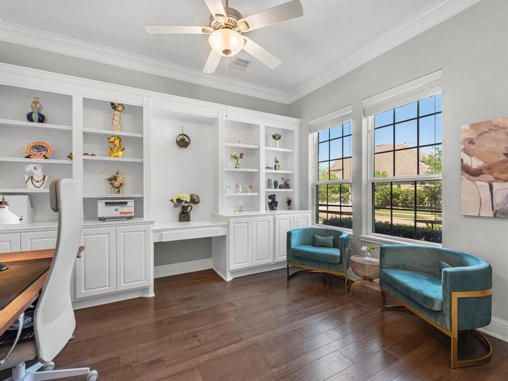 To the right of the entry is the beautiful study with built in cabinets and desk, crown molding, and large windows offering tons of natural light!