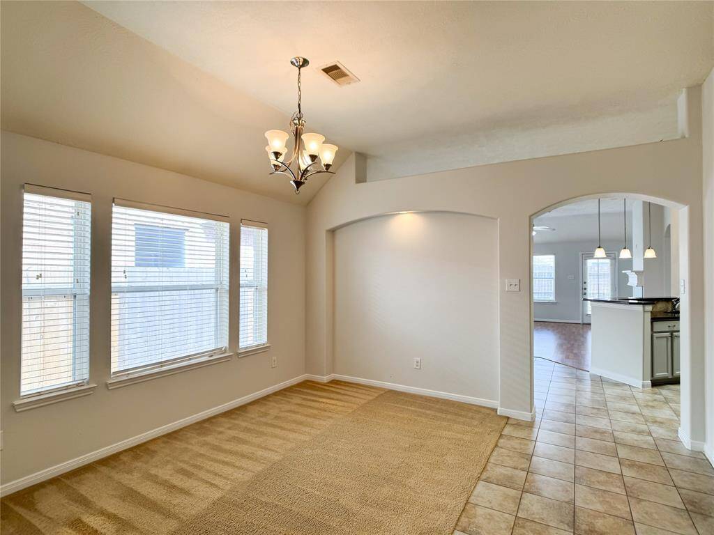 open formal dining with art niches w/museum-style lighting; arched doorways