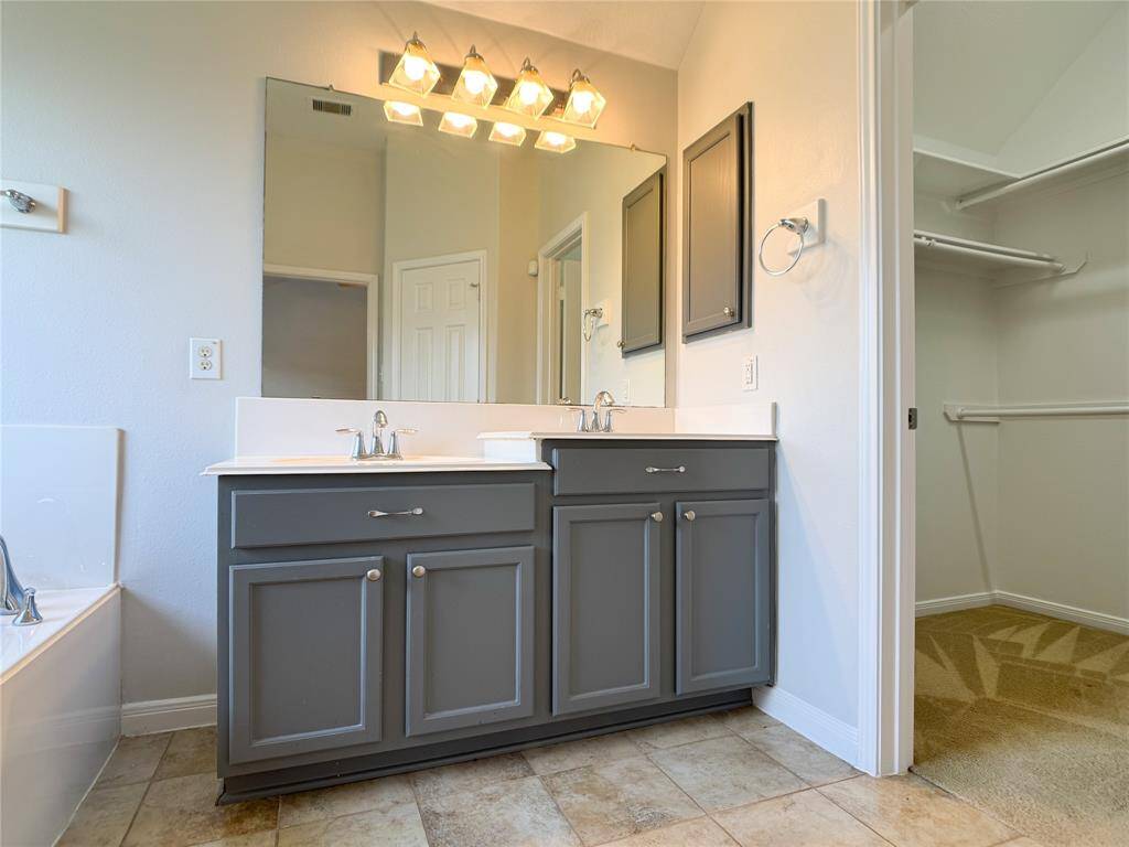primary bathroom with high-low sinks, modern fixtures