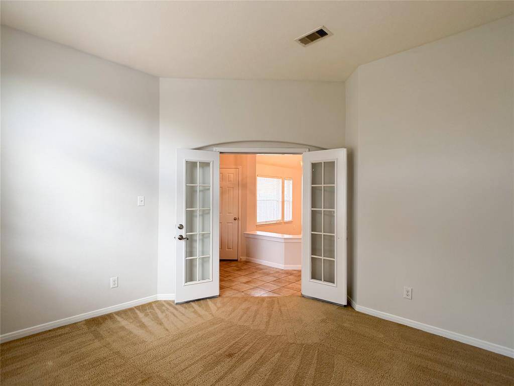 study with french doors and front entry beyond
