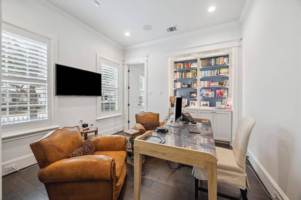 Study/Home office complete with custom shelving for a functional yet stylish workspace. This space can also function as another bedroom with an attached bathroom.