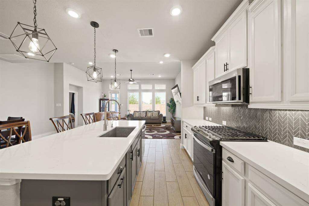 You already know this island is where everyone’s gonna gather. Game night snacks, birthday cake spreads, 'just one glass of wine' chats — it all happens right here. And that pendant lighting? Straight-up glam.