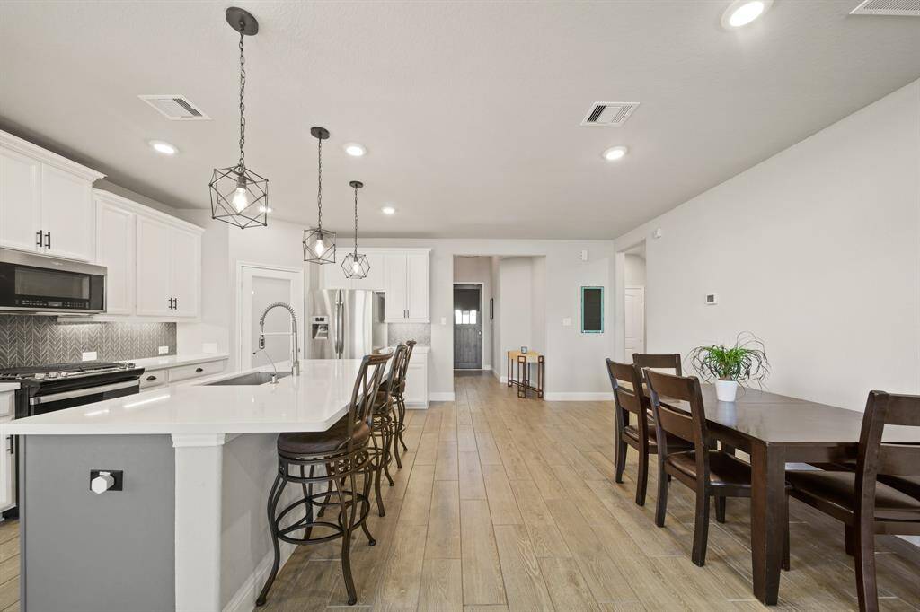 From the kitchen to the front entry, this home knows how to work a room. You're looking at form *and* function — and let’s be honest, being able to see who's at the door *without* leaving your snack zone? That’s a win.