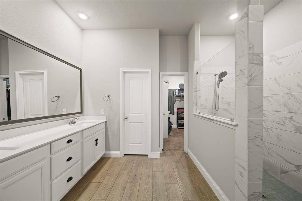 You finally get your *own* sink. No more toothpaste turf wars. These counters are quartz, the mirror is framed, and you’ve got enough drawer space to organize *and* hoard skincare.