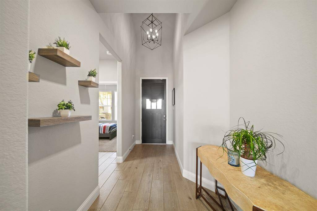This hallway is doing the most — showing off upgraded floors and open sightlines all the way to the living room. And yes, the natural light is real. You haven’t even seen the kitchen yet and you’re already sold.