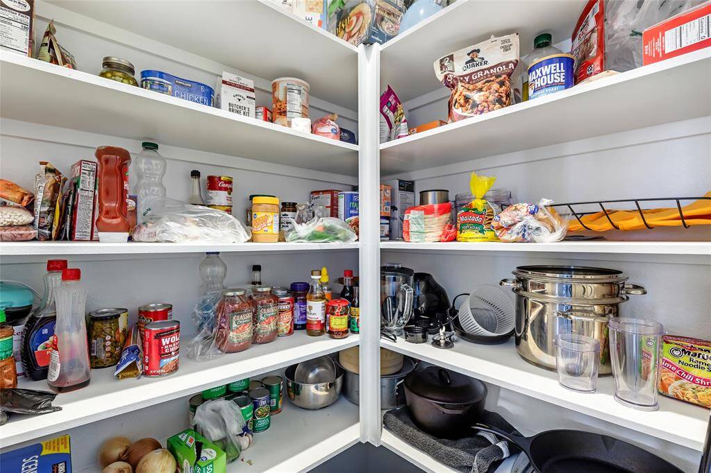 Spacious pantry with well-organized shelves, stocked with various food items and kitchen essentials. Perfect for storage and easy access to supplies.