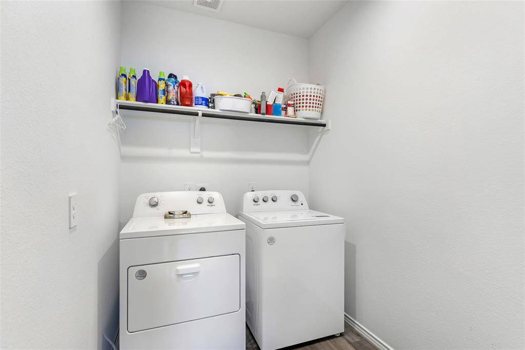 Compact laundry room featuring a wall-mounted shelf for storage. Bright and functional space for household chores.