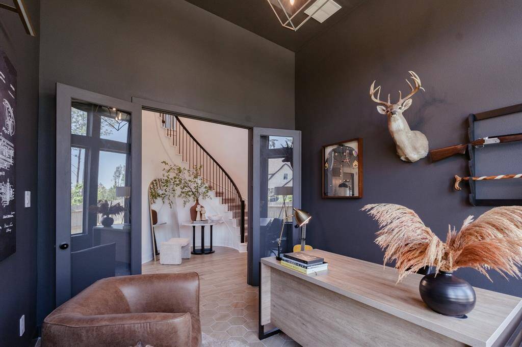 Command attention in this sophisticated home office, boasting a striking dark color palette accented by architectual winows. This executive-style workspace is both stylish and functional. Designer details - custom light fixture and paint