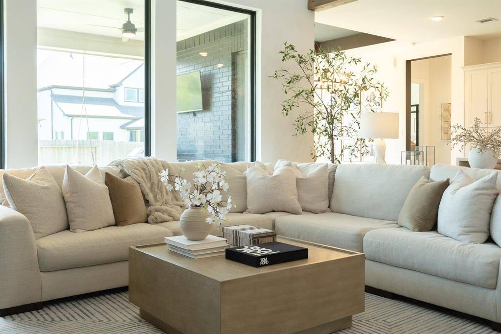 Large windows frame the stunning back patio, seamlessly blending indoor and outdoor living. Designer detail - custom painted windows