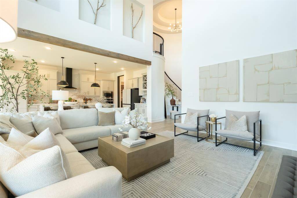 Upgrades at every turn! From the striking tray ceiling above the staircase to the natural wood beams, no detail has been overlooked in this beautifully crafted home.