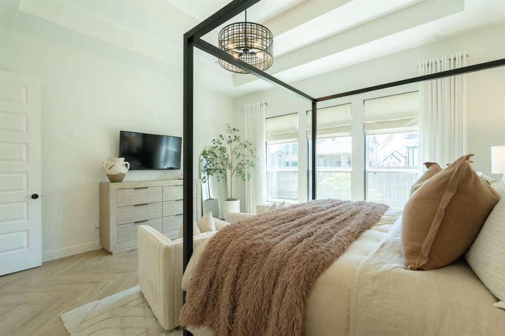 The primary suite is a true retreat, with every detail carefully considered—from the tray ceilings to the soothing neutral color palette.