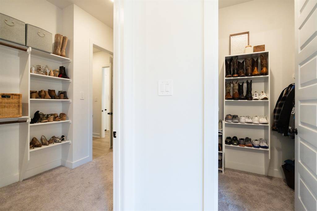It's said that separate closets are the key to a healthy home life - and made even better with built-in organization and laundry access! The neutral color palette creates a clean and bright atmosphere.