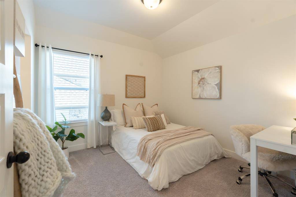 This secondary bedroom is bathed in soft, neutral tones, creating a serene and inviting space that’s perfect for relaxation or rest.