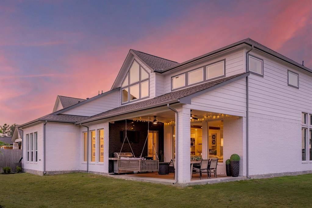 The back of the house is lined with windows, flooding the space with natural light and offering beautiful views of the outdoors.