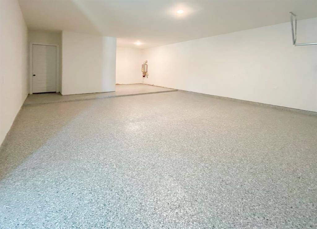Epoxy floor adds durability and a touch of elegance to the spacious 3-car garage.