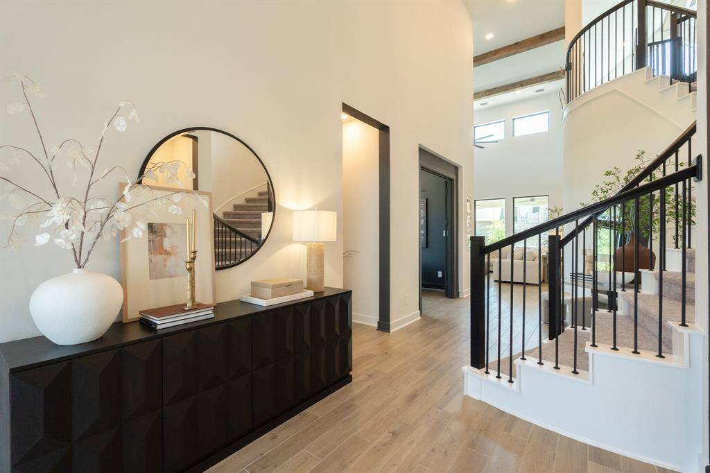 Clean lines, soaring ceilings, and a curated design aesthetic welcome you into this beautifully crafted, professionally designed home.