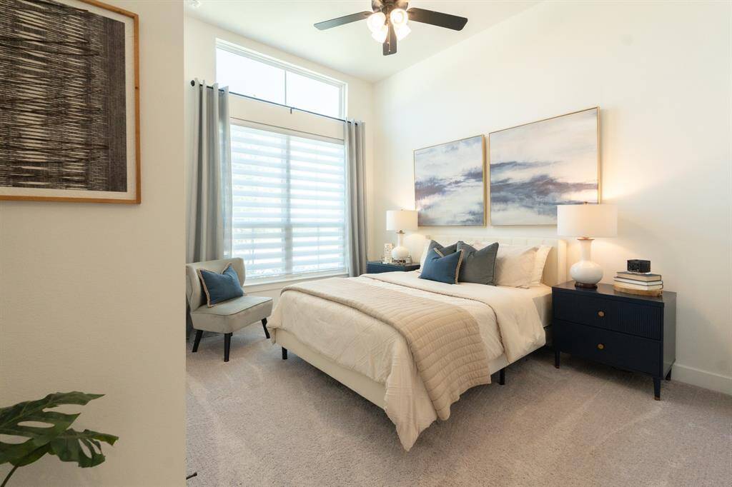 Relax and unwind in this main-floor guest bedroom suite, featuring calming neutral tones and natural light.  It's the perfect retreat for peaceful nights and restful mornings.