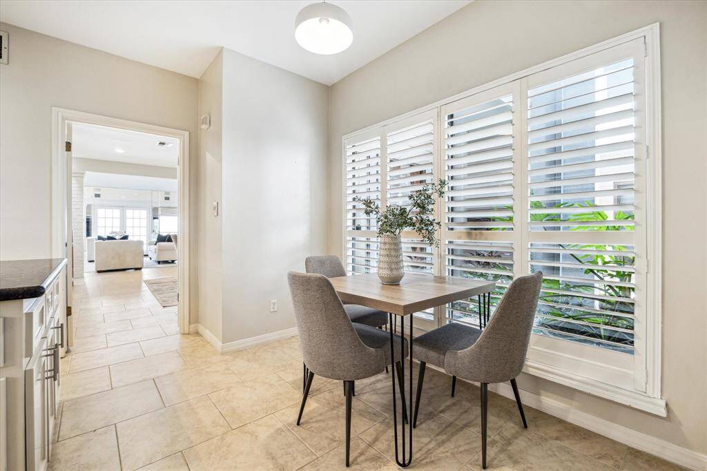 Calming views out over the lush green front porch. Note the plantation shutters.
