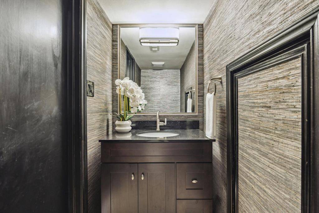 POWDER.   Incredibly stylish updated powder room with cloth wallpaper and New York boutique hotel decor influence.