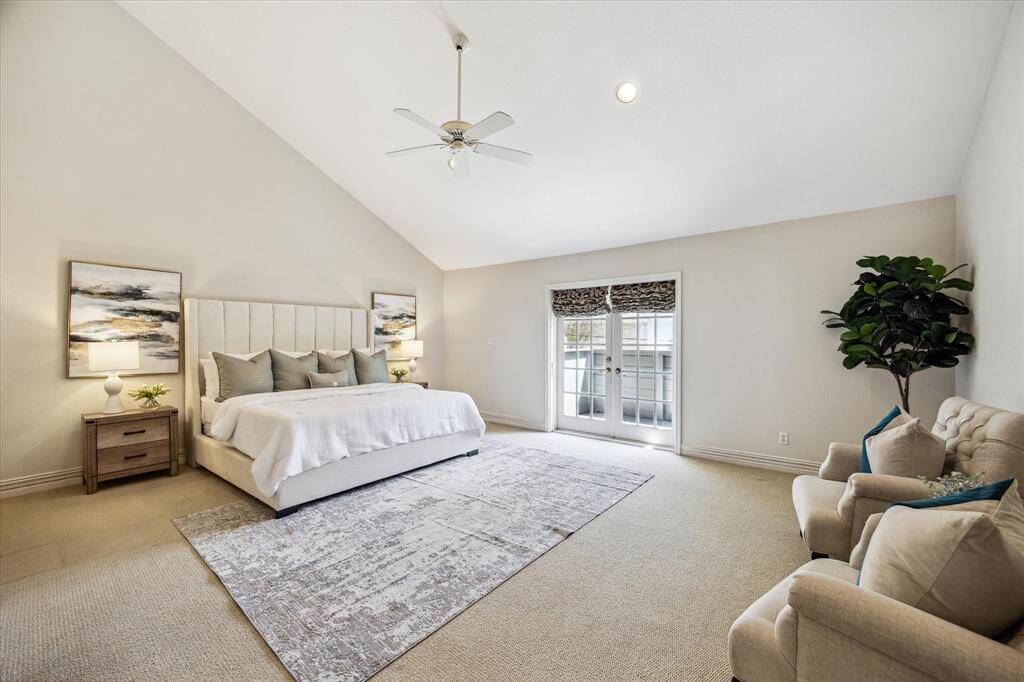 PRIMARY BEDROOM.   Wow.   How many primary bedrooms can boast a ceiling like this!  The room easily accommodates a king sized bed and seating area.