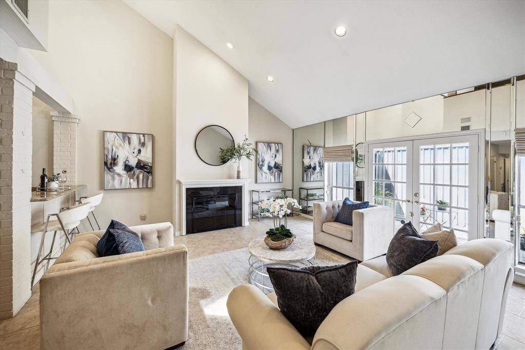 The living room is anchored around a fireplace, perfect for colder days.
