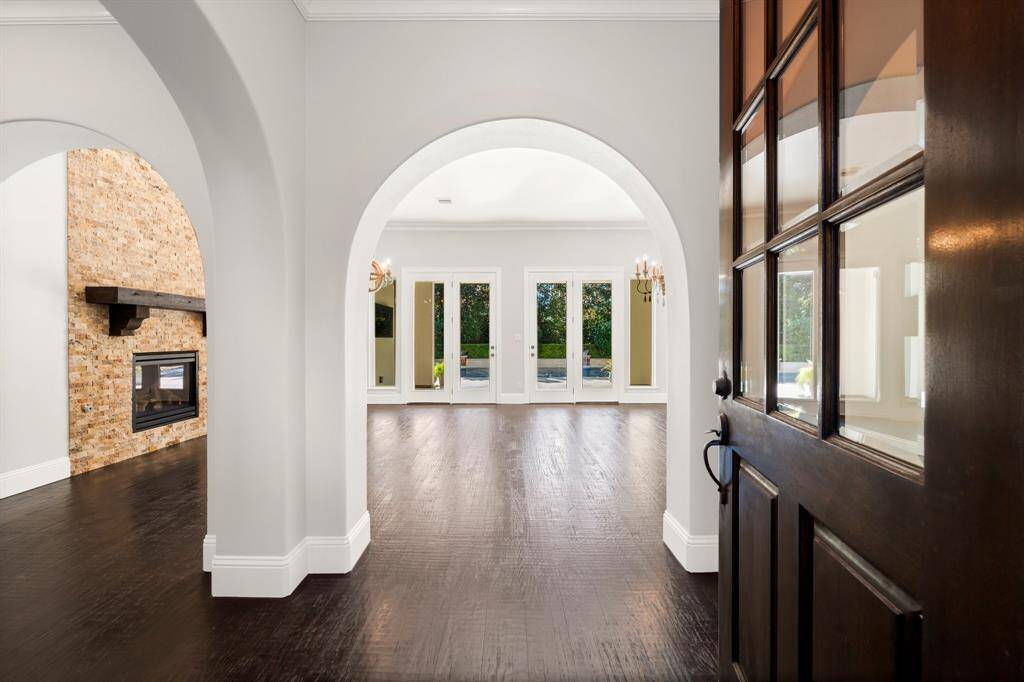 This home greets you with stunning full arches and views out to the lush backyard pool area
