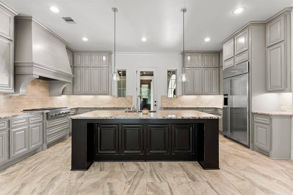 A built-in refrigerator and island offer added convenience.