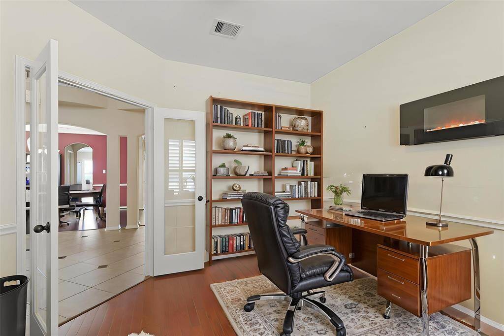 Virtually Staged: This home office is the perfect place to read your favorite book or get some work done! It boasts gorgeous double glass doors.