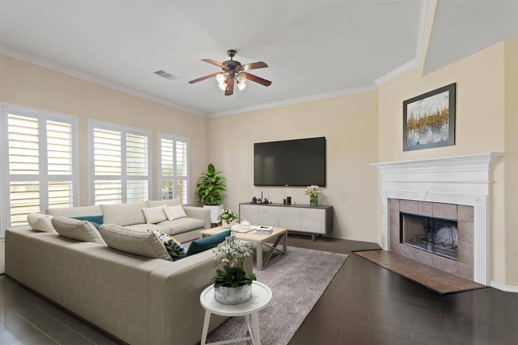 Virtually Staged: Stunning living room with tile floors, a ceiling, crown molding details, and a gorgeous fireplace with mantle.