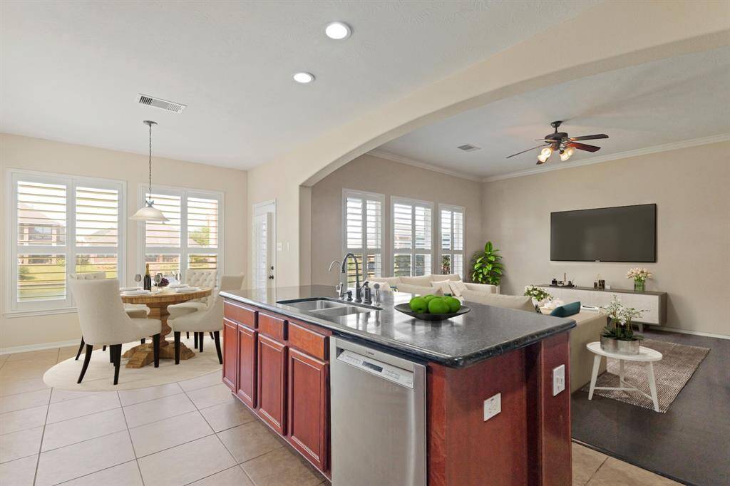 Virtually Staged: Beautiful breakfast nook open to the kitchen and living room, featuring a pendant lighting, and shutters. This is an entertainers paradise! Whip up a meal for your family, friends, and guests while still being a part of all of the action!