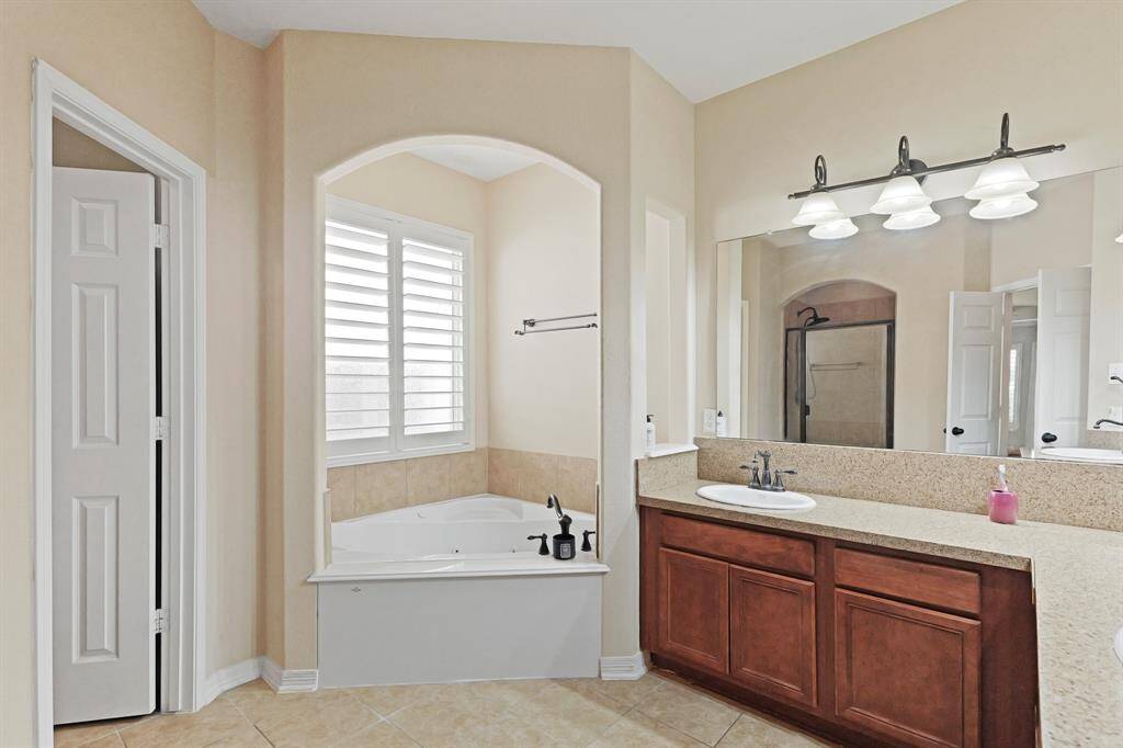 This Primary Bathroom is incredible! Check out the soaking tub with a large window, this will be your new favorite place to sit, drink a glass of wine and relax after a long day!