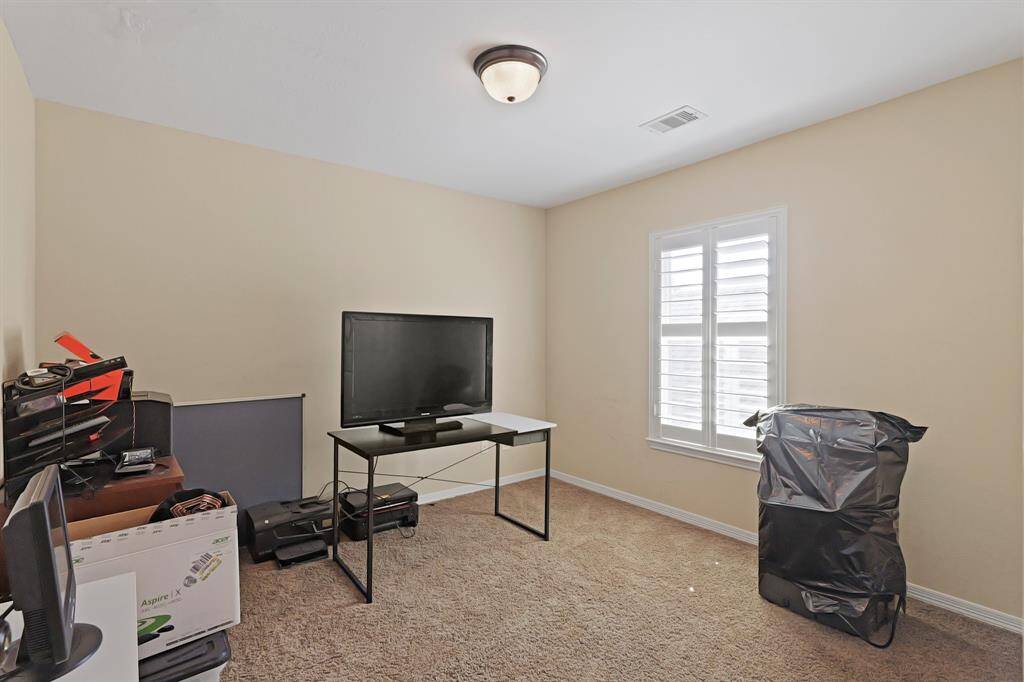 Secondary bedroom with carpet floors.