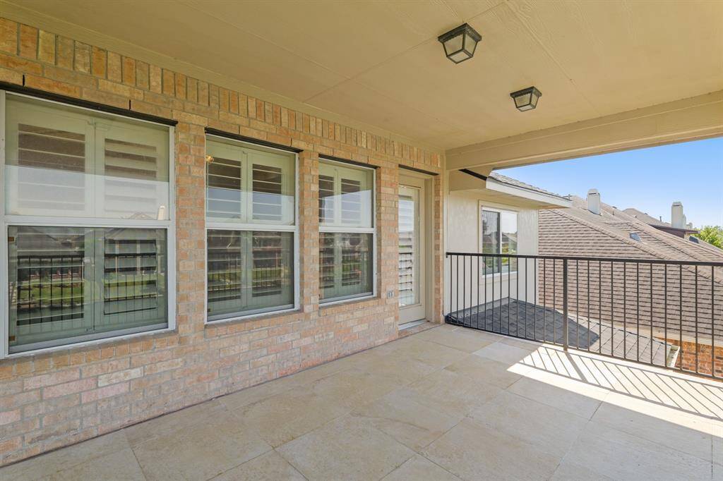 This balcony just outside the family room has brick accent walls, and tile floors.