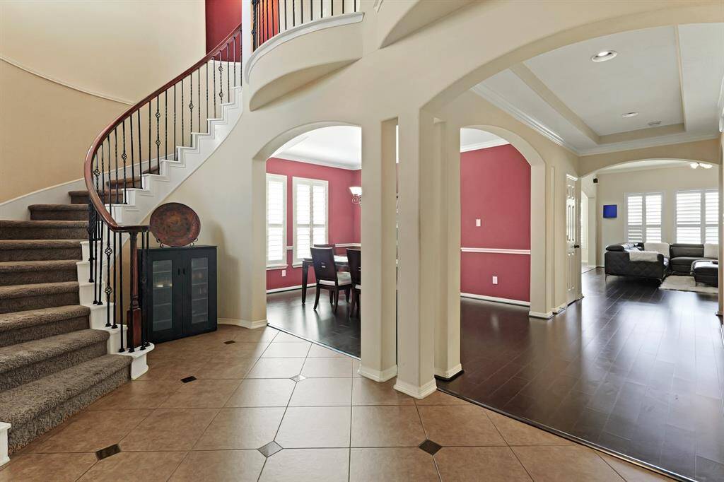 You'll be instantly greeted by beautiful tile floors, a charming stair case, and a view straight back into the backyard.