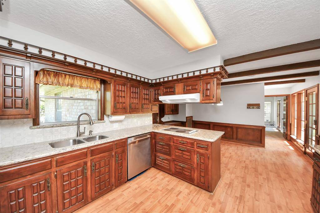 The kitchen sink offers a pleasant view of the outdoors, making everyday tasks like doing the dishes a bit more enjoyable.