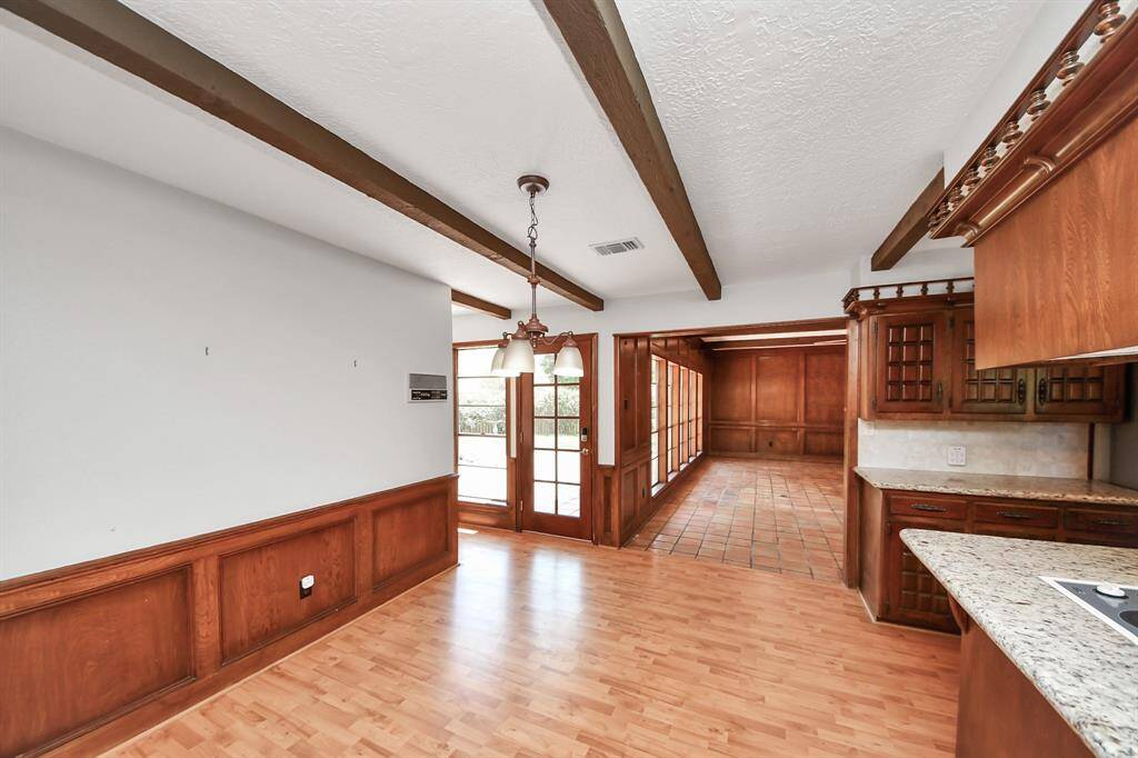 The spacious breakfast area is accented by classic wood wainscoting on the walls, making it a welcoming spot for snacks and quick, casual meals.