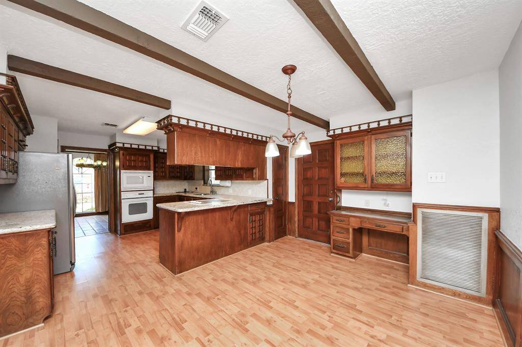 A built-in desk area within the kitchen space offers a convenient spot for homework, bill paying, and staying organized.