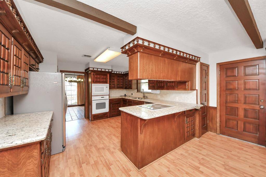 Here is one more look at the entire kitchen area, complete with a view into the dining room—showing the home's flow and functional design.