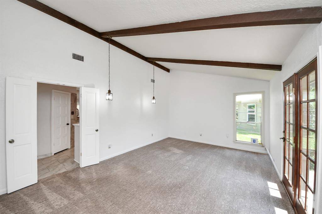The owner's retreat is thoughtfully situated away from the secondary bedrooms, offering added privacy. This substantial room provides ample space and versatility, with plenty of room for a sitting area or personalized layout.