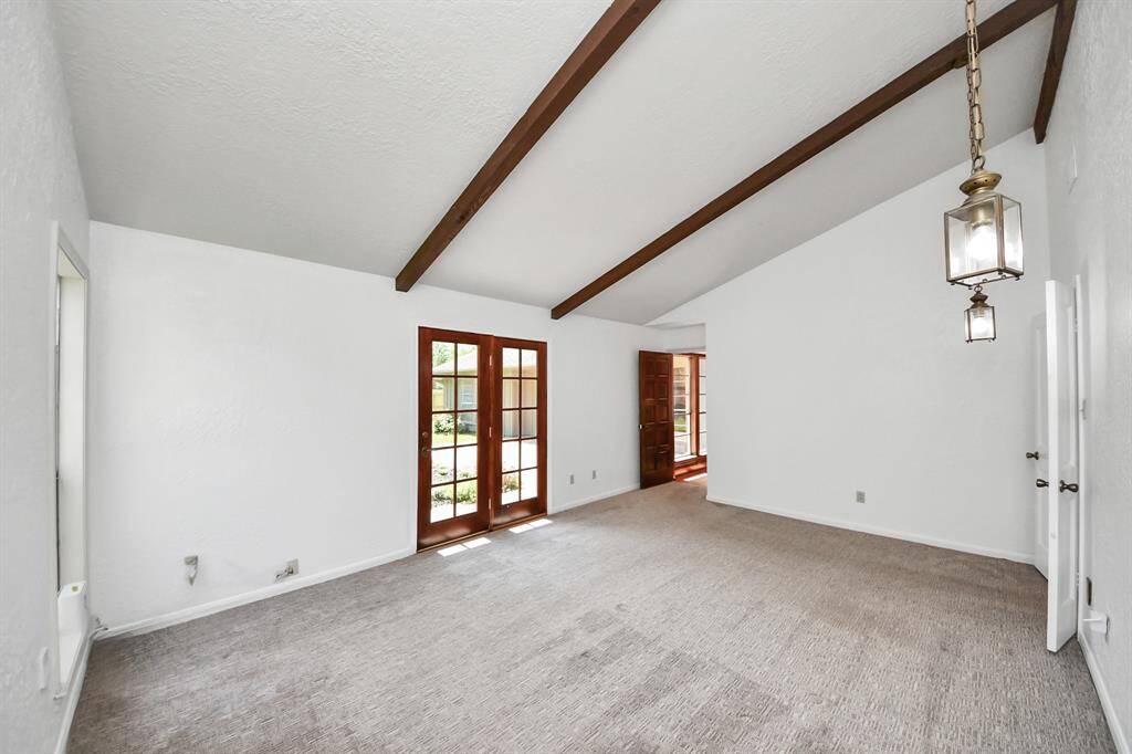 Recent carpeting and high ceilings are additional standout features of this primary bedroom, enhancing its spacious atmosphere.