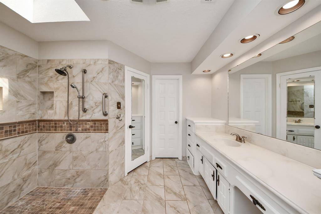 The updated, massive walk-in shower offers a spacious and inviting retreat, designed for easy access and a luxurious experience.