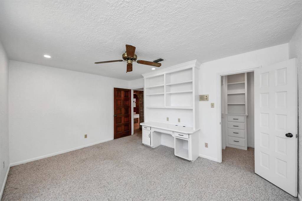 Both secondary bedrooms feature walk-in closets and built-in desks, offering practical storage solutions and a dedicated space for work or study, making them perfect for growing children or guests.