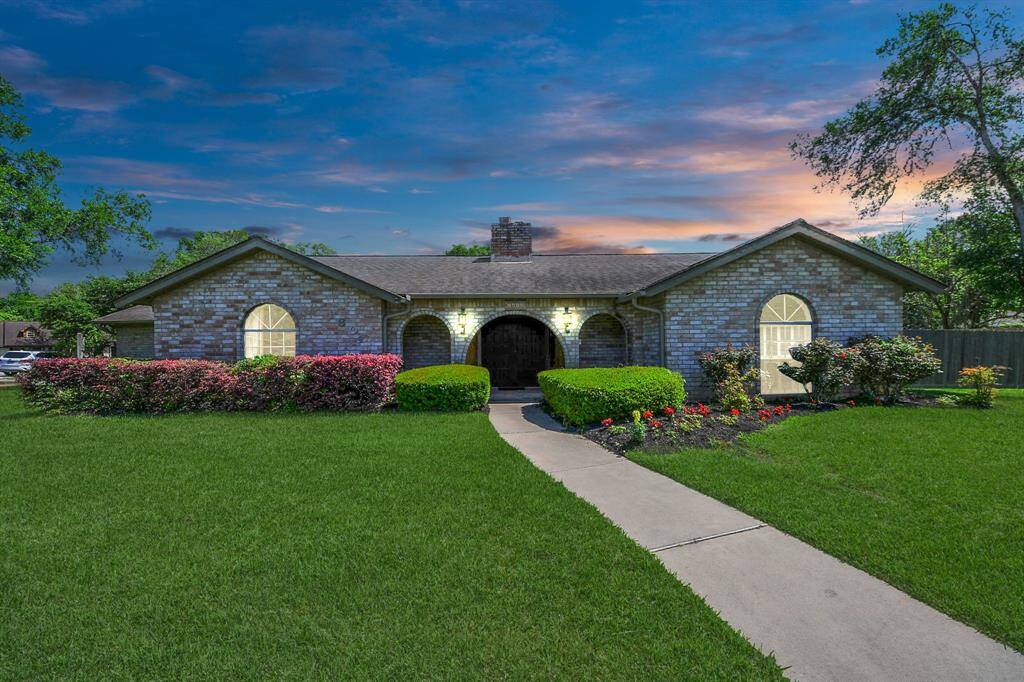 This home exudes a stately presence at night, highlighted by the architectural charm and landscaped surroundings.