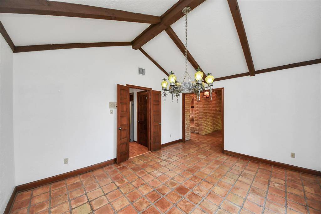 Access to the kitchen is seamless in this dining room, with solid wood double doors that not only provide easy entry but can also be closed for privacy, offering flexibility and convenience for both open gatherings or more intimate settings.